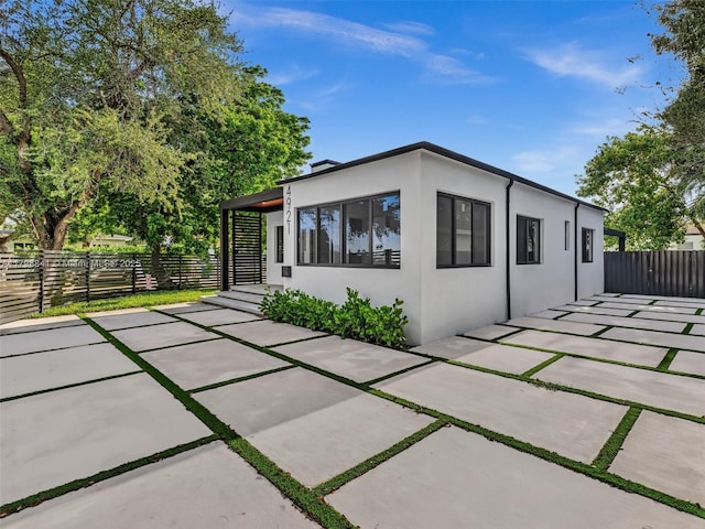 4921 NW 6th Ave, Miami, FL 33127 - rear view of property featuring stucco siding, a patio, and fence