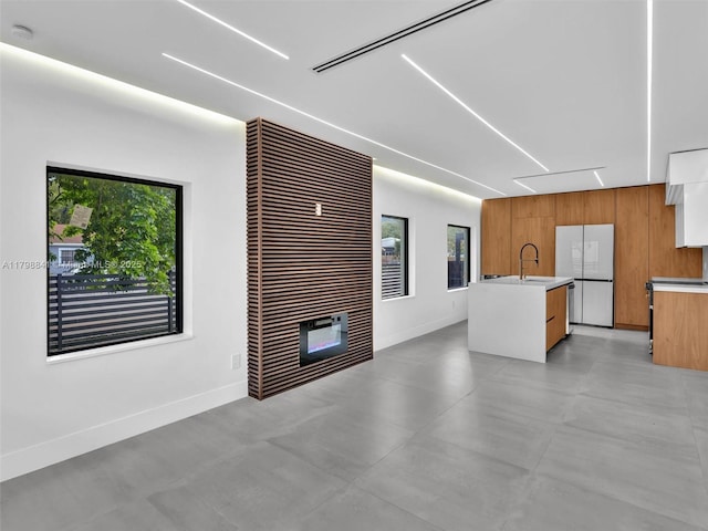 4921 NW 6th Ave, Miami, FL 33127 - unfurnished living room featuring a sink, attic access, plenty of natural light, and baseboards