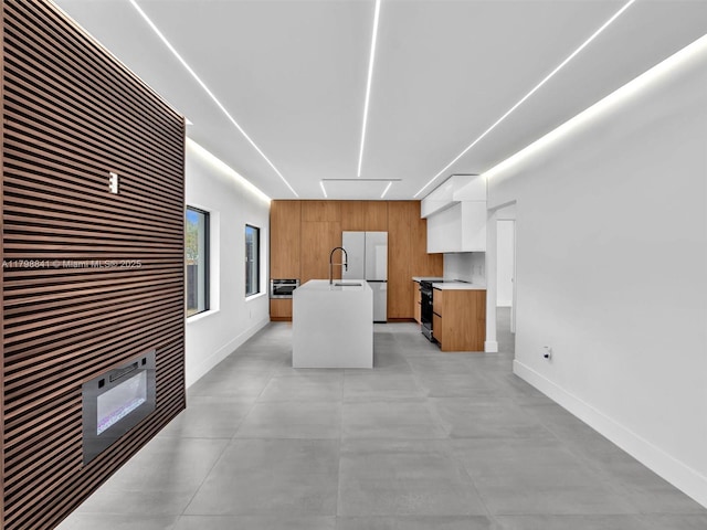 4921 NW 6th Ave, Miami, FL 33127 - kitchen featuring modern cabinets, light countertops, brown cabinetry, and baseboards