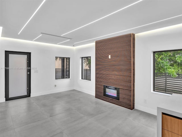 4921 NW 6th Ave, Miami, FL 33127 - unfurnished living room featuring baseboards and a tile fireplace