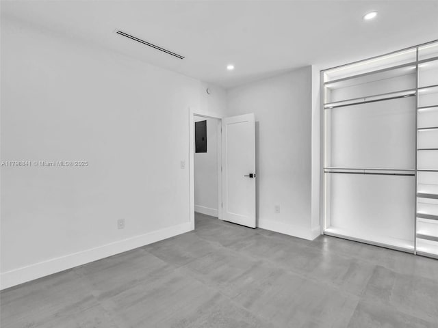 4921 NW 6th Ave, Miami, FL 33127 - unfurnished bedroom with recessed lighting, electric panel, concrete flooring, baseboards, and a closet
