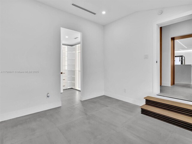 4921 NW 6th Ave, Miami, FL 33127 - spare room featuring concrete flooring, baseboards, recessed lighting, vaulted ceiling, and a smoke detector