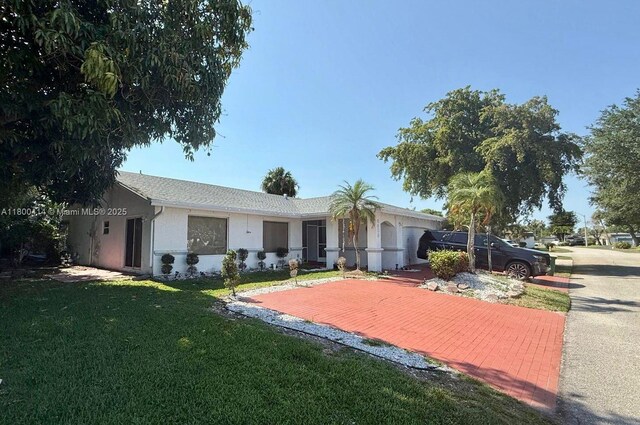 4909 Bayberry Ln, Tamarac, FL 33319 - ranch-style house with a front lawn and stucco siding