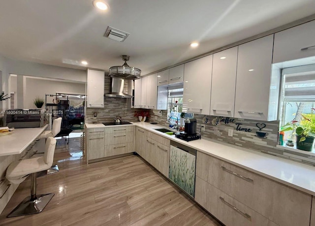 4909 Bayberry Ln, Tamarac, FL 33319 - kitchen with wall chimney range hood, modern cabinets, black electric stovetop, backsplash, and recessed lighting