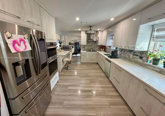 4909 Bayberry Ln, Tamarac, FL 33319 - kitchen with appliances with stainless steel finishes, modern cabinets, decorative backsplash, light countertops, and recessed lighting