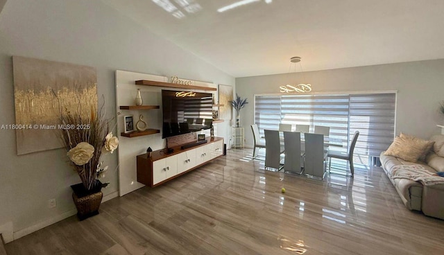 4909 Bayberry Ln, Tamarac, FL 33319 - living area featuring vaulted ceiling, a chandelier, and wood finished floors