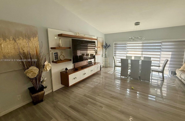 4909 Bayberry Ln, Tamarac, FL 33319 - living area featuring vaulted ceiling, wood finished floors, and a chandelier