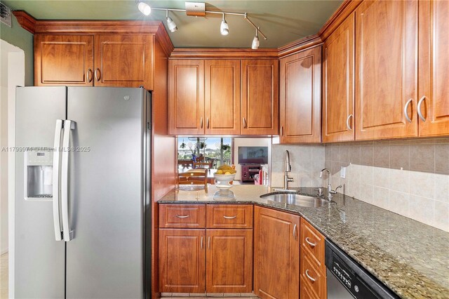 4800 Hillcrest Ln Unit 503, Hollywood, FL 33021 - kitchen with stainless steel refrigerator with ice dispenser, brown cabinetry, dark stone counters, and decorative backsplash