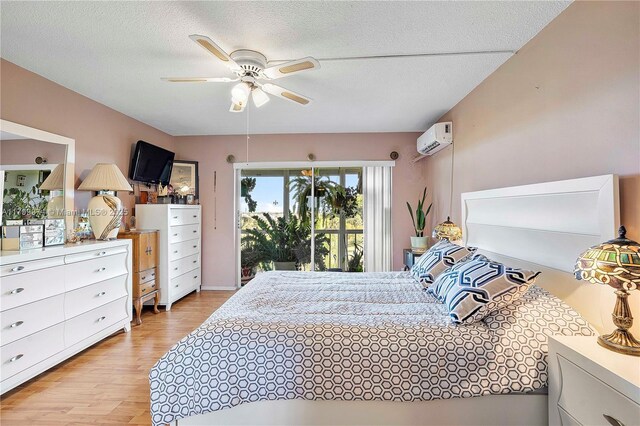 4800 Hillcrest Ln Unit 503, Hollywood, FL 33021 - bedroom featuring a wall mounted air conditioner, light wood-type flooring, access to exterior, a textured ceiling, and ceiling fan