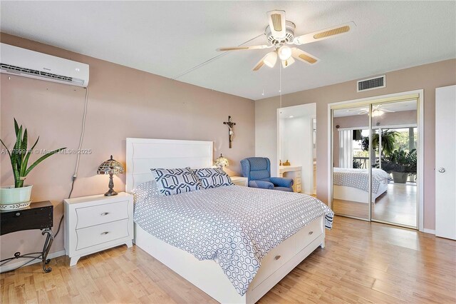 4800 Hillcrest Ln Unit 503, Hollywood, FL 33021 - bedroom featuring light wood-style flooring, a wall mounted air conditioner, and a ceiling fan