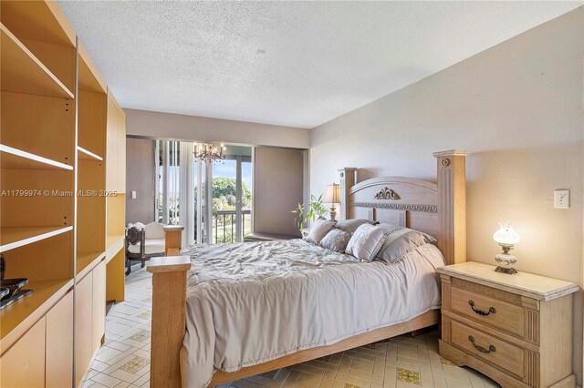 4800 Hillcrest Ln Unit 503, Hollywood, FL 33021 - bedroom with a chandelier, access to exterior, and a textured ceiling