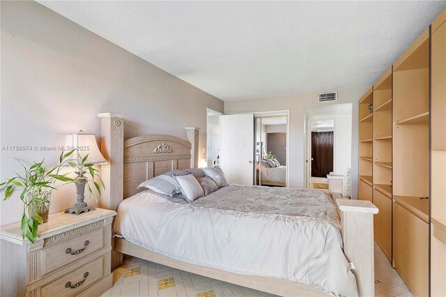 4800 Hillcrest Ln Unit 503, Hollywood, FL 33021 - bedroom with light tile patterned floors and ensuite bathroom