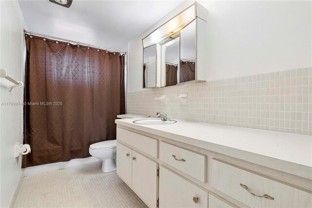 4800 Hillcrest Ln Unit 503, Hollywood, FL 33021 - bathroom featuring vanity, tile patterned floors, tile walls, and backsplash