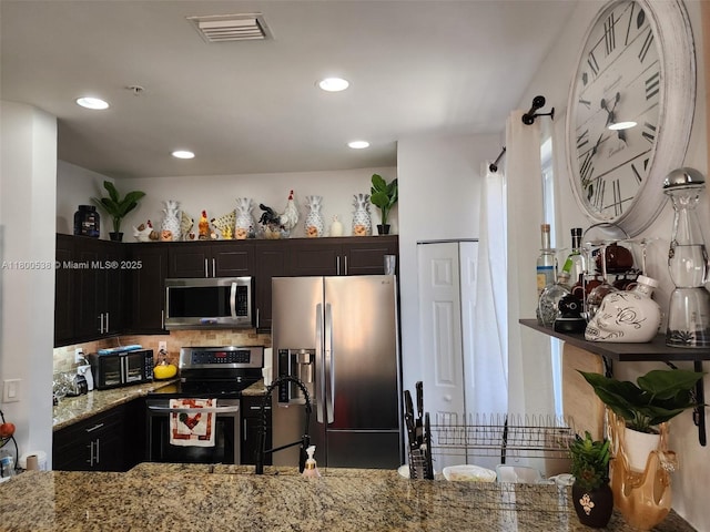 12430 SW 50th St Unit 147, Miramar, FL 33027 - kitchen featuring appliances with stainless steel finishes, a sink, light stone counters, backsplash, and recessed lighting