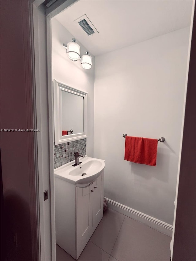 12430 SW 50th St Unit 147, Miramar, FL 33027 - bathroom with tile patterned floors, decorative backsplash, vanity, and baseboards