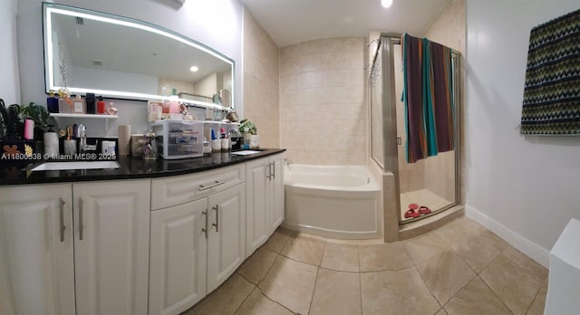 12430 SW 50th St Unit 147, Miramar, FL 33027 - bathroom featuring a shower stall, a garden tub, baseboards, double vanity, and tile patterned floors