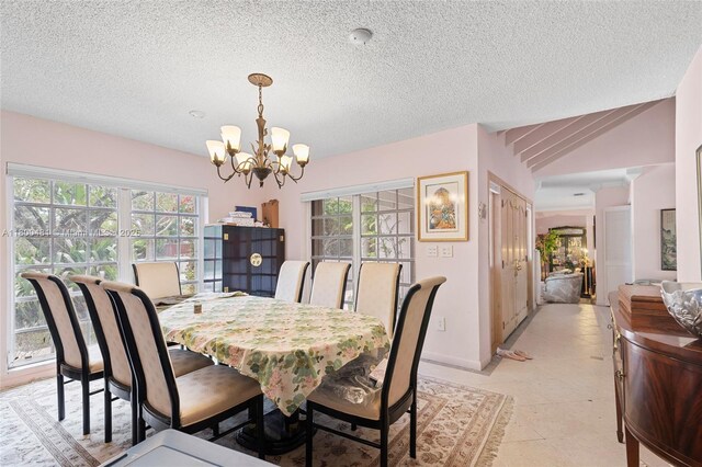 9905 SW 131st St, Miami, FL 33176 - dining area featuring a chandelier, plenty of natural light, baseboards, a textured ceiling, and light tile patterned floors