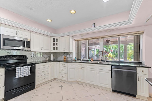 9905 SW 131st St, Miami, FL 33176 - kitchen featuring stainless steel appliances, decorative backsplash, a sink, white cabinetry, and recessed lighting