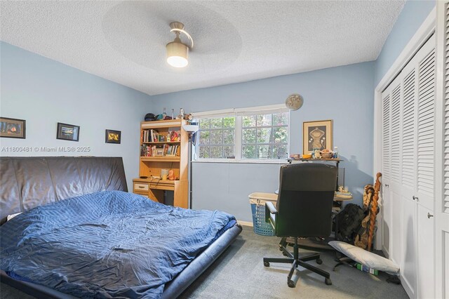 9905 SW 131st St, Miami, FL 33176 - carpeted bedroom with a closet, a desk, a textured ceiling, and a ceiling fan
