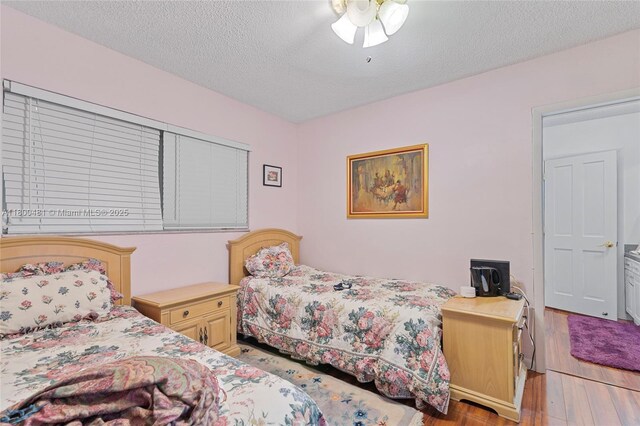 9905 SW 131st St, Miami, FL 33176 - bedroom with wood finished floors and a textured ceiling