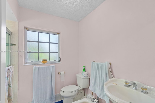 9905 SW 131st St, Miami, FL 33176 - bathroom with a sink, toilet, a shower, a textured ceiling, and a bidet