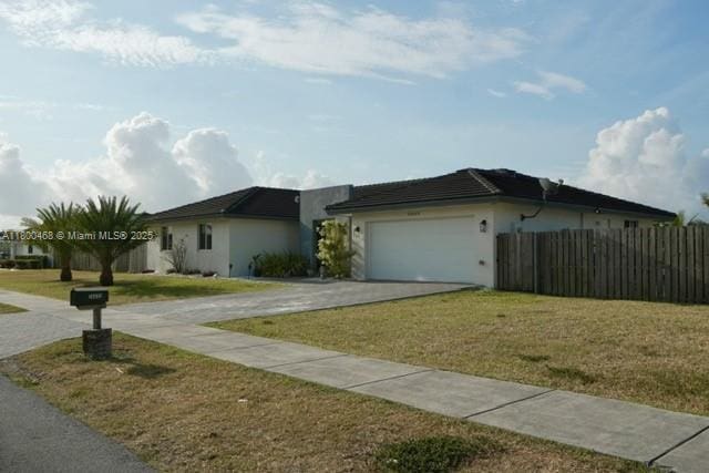 20600 SW 316th St, Homestead, FL 33030 - view of front of house featuring driveway, an attached garage, and stucco siding