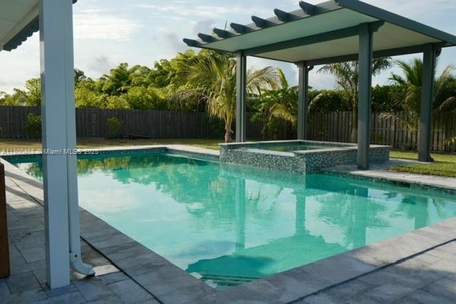 20600 SW 316th St, Homestead, FL 33030 - view of pool with a fenced backyard and a pool with connected hot tub