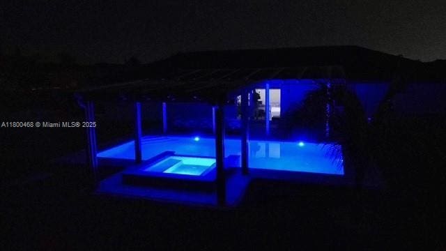 20600 SW 316th St, Homestead, FL 33030 - pool at night featuring an in-ground hot tub