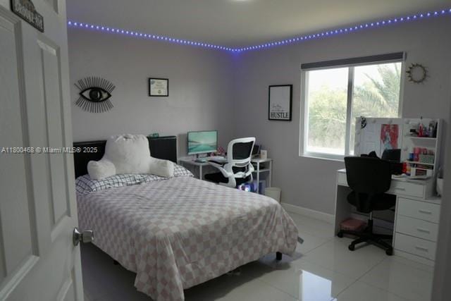 20600 SW 316th St, Homestead, FL 33030 - bedroom with an office area, tile patterned flooring, and baseboards