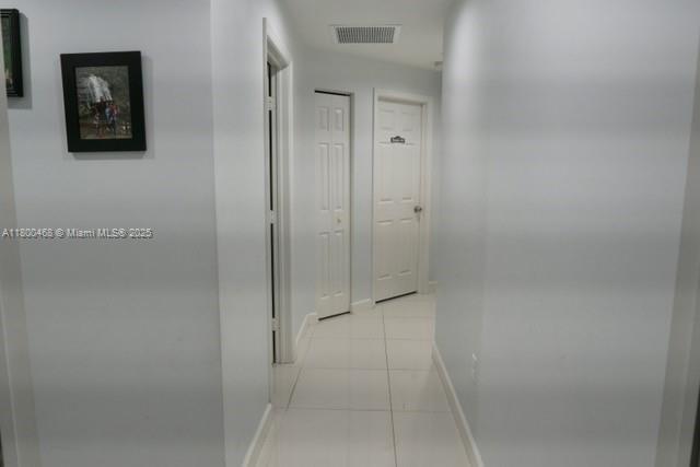 20600 SW 316th St, Homestead, FL 33030 - hall featuring light tile patterned flooring and baseboards