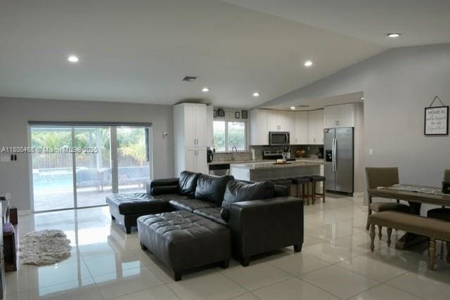 20600 SW 316th St, Homestead, FL 33030 - living room with lofted ceiling, recessed lighting, and light tile patterned flooring