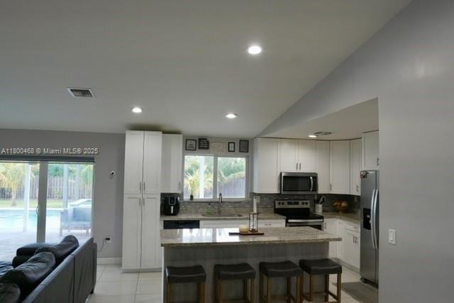 20600 SW 316th St, Homestead, FL 33030 - kitchen with stainless steel appliances, a sink, decorative backsplash, recessed lighting, and white cabinetry