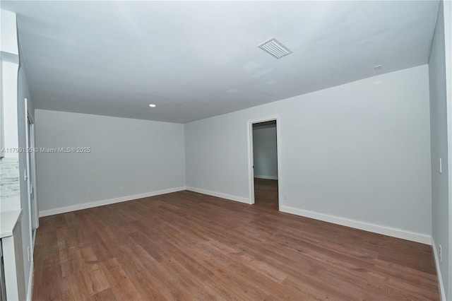 empty room with wood finished floors and baseboards