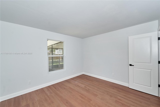 empty room with wood finished floors and baseboards