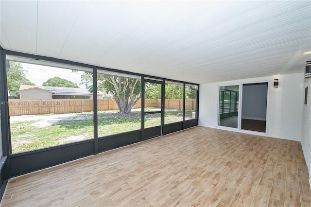 unfurnished sunroom with healthy amount of natural light