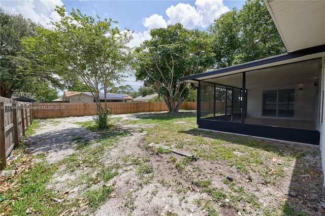 fenced backyard featuring a patio area and a sunroom