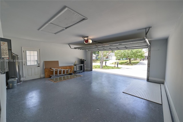 garage with a garage door opener and baseboards