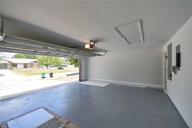 garage featuring a garage door opener and baseboards