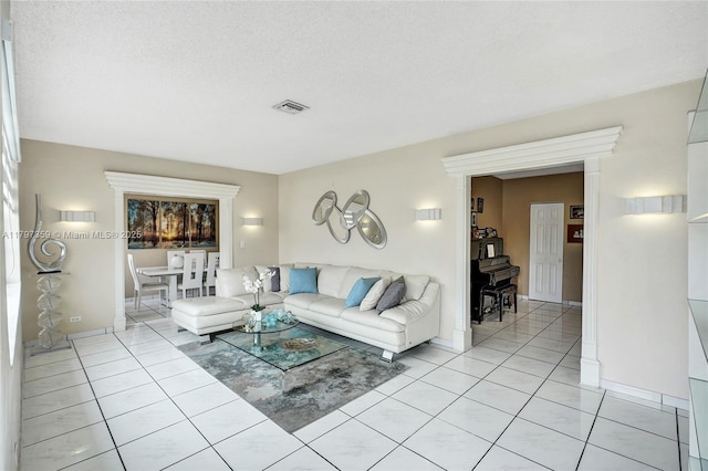 707 W 39th Pl, Hialeah, FL 33012 - living area featuring light tile patterned floors and a textured ceiling
