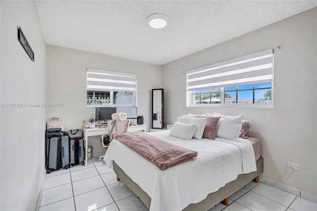 707 W 39th Pl, Hialeah, FL 33012 - bedroom featuring a textured ceiling, light tile patterned floors, and an office area