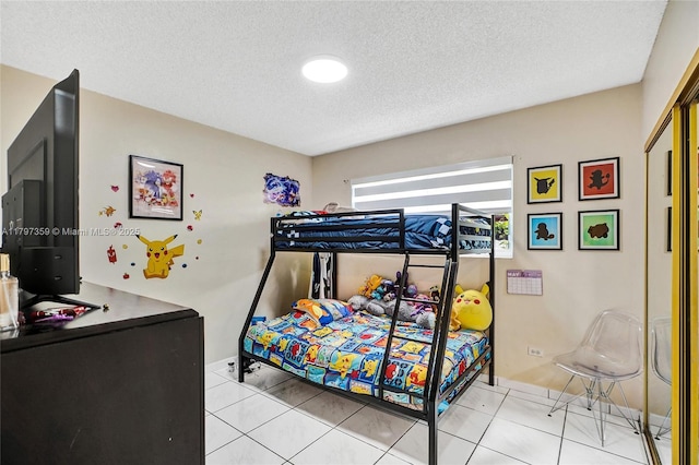 707 W 39th Pl, Hialeah, FL 33012 - bedroom with a textured ceiling and light tile patterned flooring