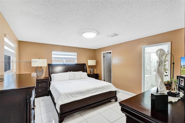 707 W 39th Pl, Hialeah, FL 33012 - bedroom with light tile patterned floors and a textured ceiling