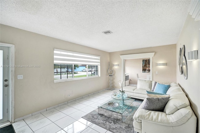 707 W 39th Pl, Hialeah, FL 33012 - tiled living area featuring a textured ceiling