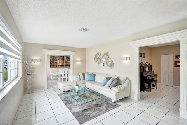 707 W 39th Pl, Hialeah, FL 33012 - living room with light tile patterned floors, a textured ceiling, and a wood stove