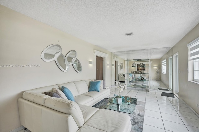 707 W 39th Pl, Hialeah, FL 33012 - living area with light tile patterned floors and a textured ceiling