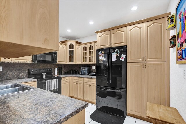 707 W 39th Pl, Hialeah, FL 33012 - kitchen featuring black appliances, light brown cabinets, backsplash, glass insert cabinets, and light tile patterned floors