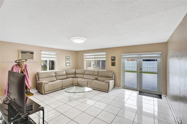 707 W 39th Pl, Hialeah, FL 33012 - living room featuring an AC wall unit, a textured ceiling, light tile patterned flooring, and french doors