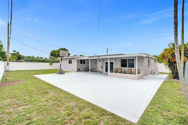 707 W 39th Pl, Hialeah, FL 33012 - rear view of house with stucco siding, a fenced backyard, and a patio area