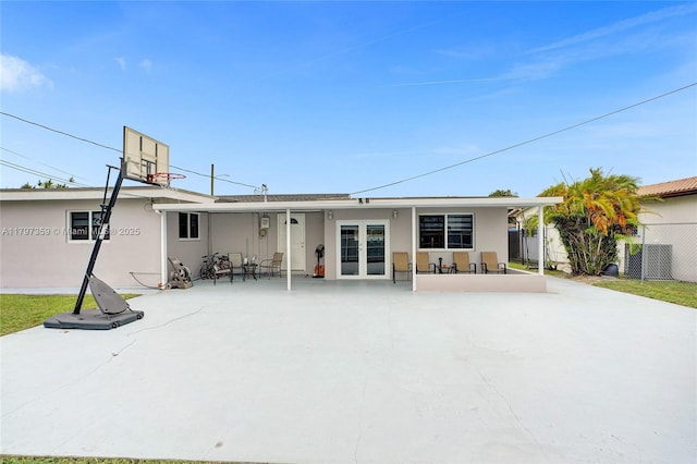 707 W 39th Pl, Hialeah, FL 33012 - rear view of property featuring stucco siding and french doors