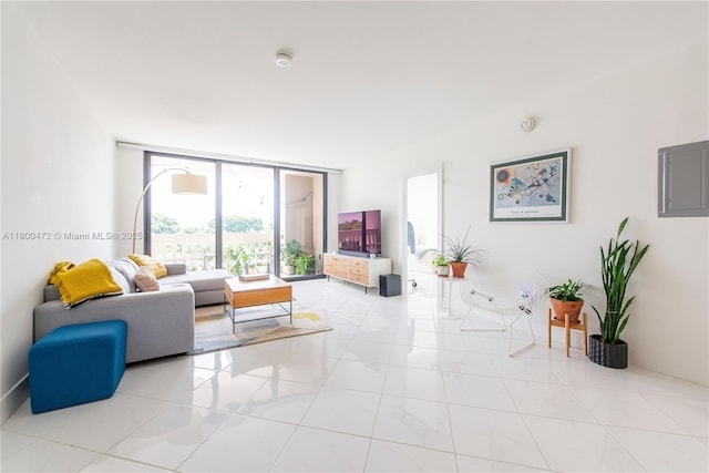 living room featuring floor to ceiling windows, tile patterned flooring, and electric panel